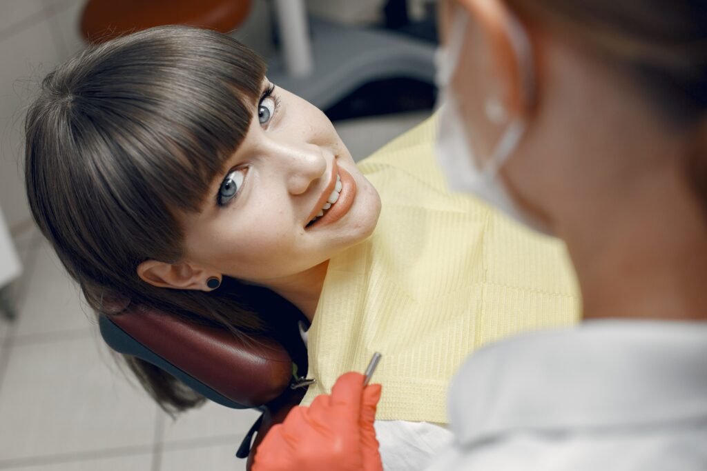 A smiling woman sitting in a dental chair.